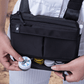 Close up of a person holding open the bottom compartment with protective padding of black Puffco Proxy bag with various accessories inside