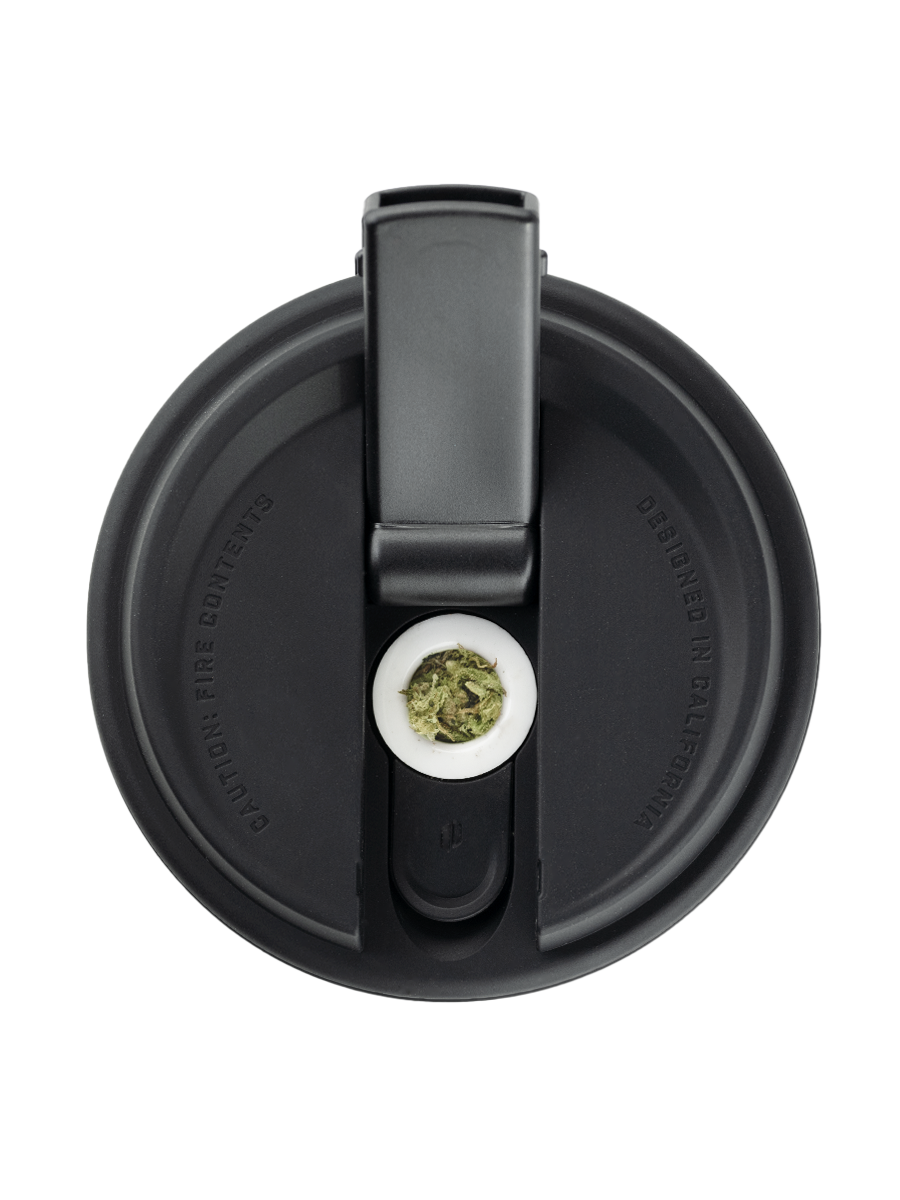 Overhead shot of Puffco black and white coffee cup pipe with flower in bowl and open mouthpiece