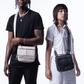 Two people side-by-side carrying black and beige Puffco Proxy bags across their bodies