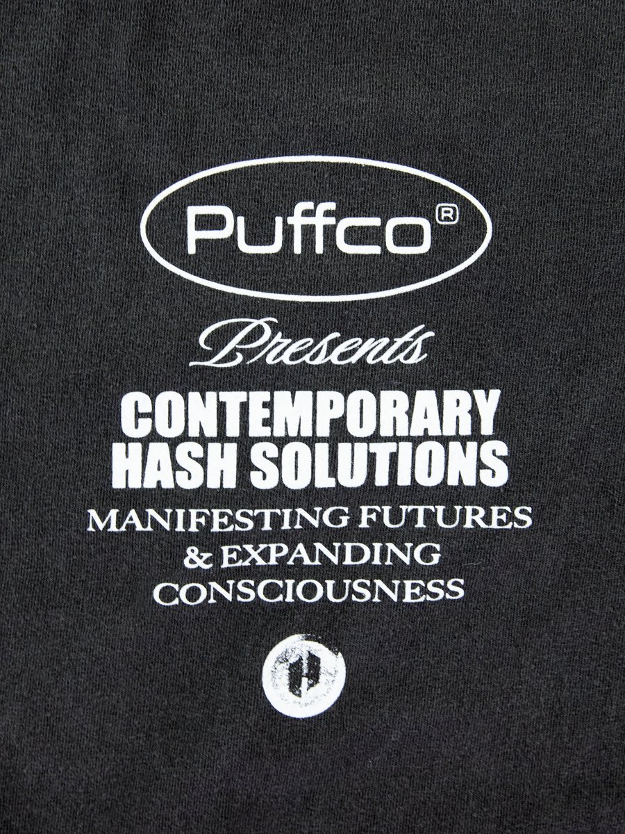 Close up of logo on Puffco shirt
