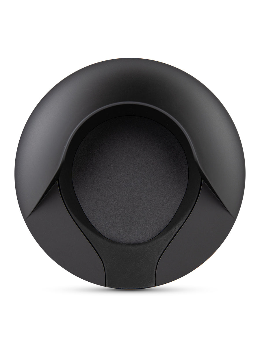 Overhead shot of black Puffco charging dock against white backdrop