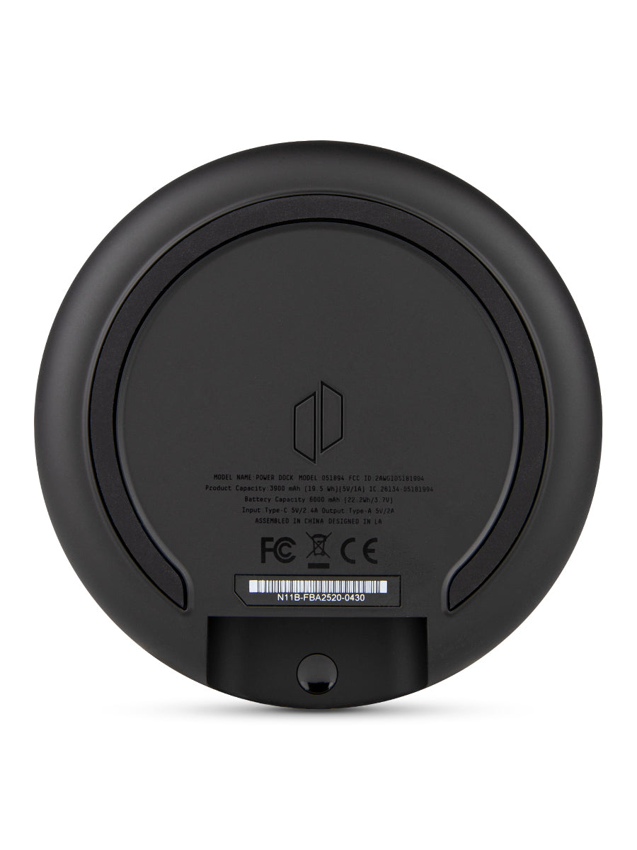 Shot of the bottom of black Puffco power dock against white backdrop