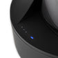 Close up shot of four small blue and white lights on black Puffco wireless charger