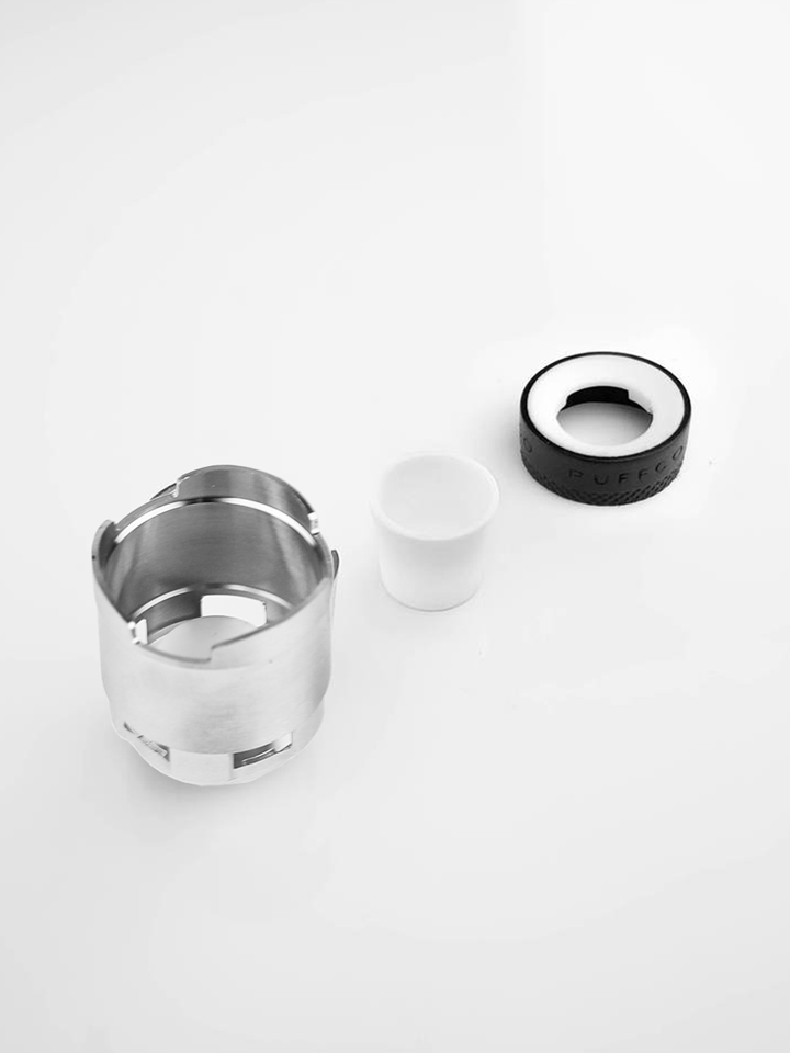 Deconstructed Puffco ceramic atomizer with three components alongside each other