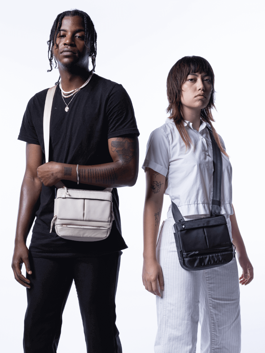Two people side-by-side carrying black and beige Puffco Proxy bags across their bodies